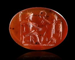 A CARNELIAN INTAGLIO SHOWING JUPITER SEATED WITH VICTORY, 2ND-3RD CENTURY AD