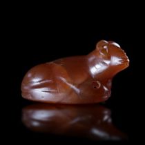 A RECLINING BULL AMULET IN CARNELIAN, EASTERN MEDITERRANEAN, 6TH CENTURY BC