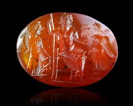 A ROMAN CARNELIAN INTAGLIO OF JUPITER FLANKED BY FORTUNA AND VICTORIA, 2ND-3RD CENTURY AD