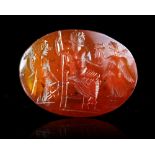 A ROMAN CARNELIAN INTAGLIO OF JUPITER FLANKED BY FORTUNA AND VICTORIA, 2ND-3RD CENTURY AD