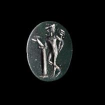 A ROMAN INTAGLIO WITH MERCURY LEANING ON A COLUMN IN BLACK JASPER, 2ND-3RD CENTURY AD