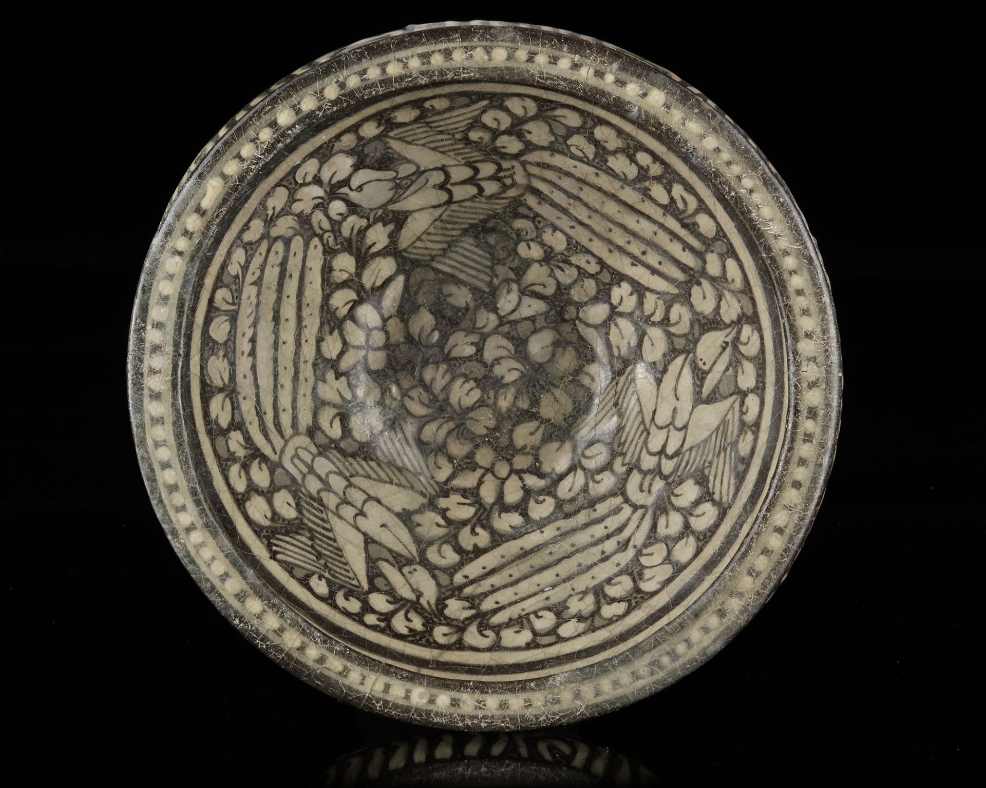 A BOWL DECORATED WITH THREE BIRDS IN FLIGHT, SULTANABAD, 13TH-14TH CENTURY