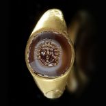 A ROMAN GOLD RING WITH AN AGATE INTAGLIO WITH MEDUSA, 1ST CENTURY AD