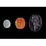 TWO ROMAN INTAGLIOS AND A LATER CAST GLASS IMPRESSION, 2ND CENTURY AD AND 19TH CENTURY AD