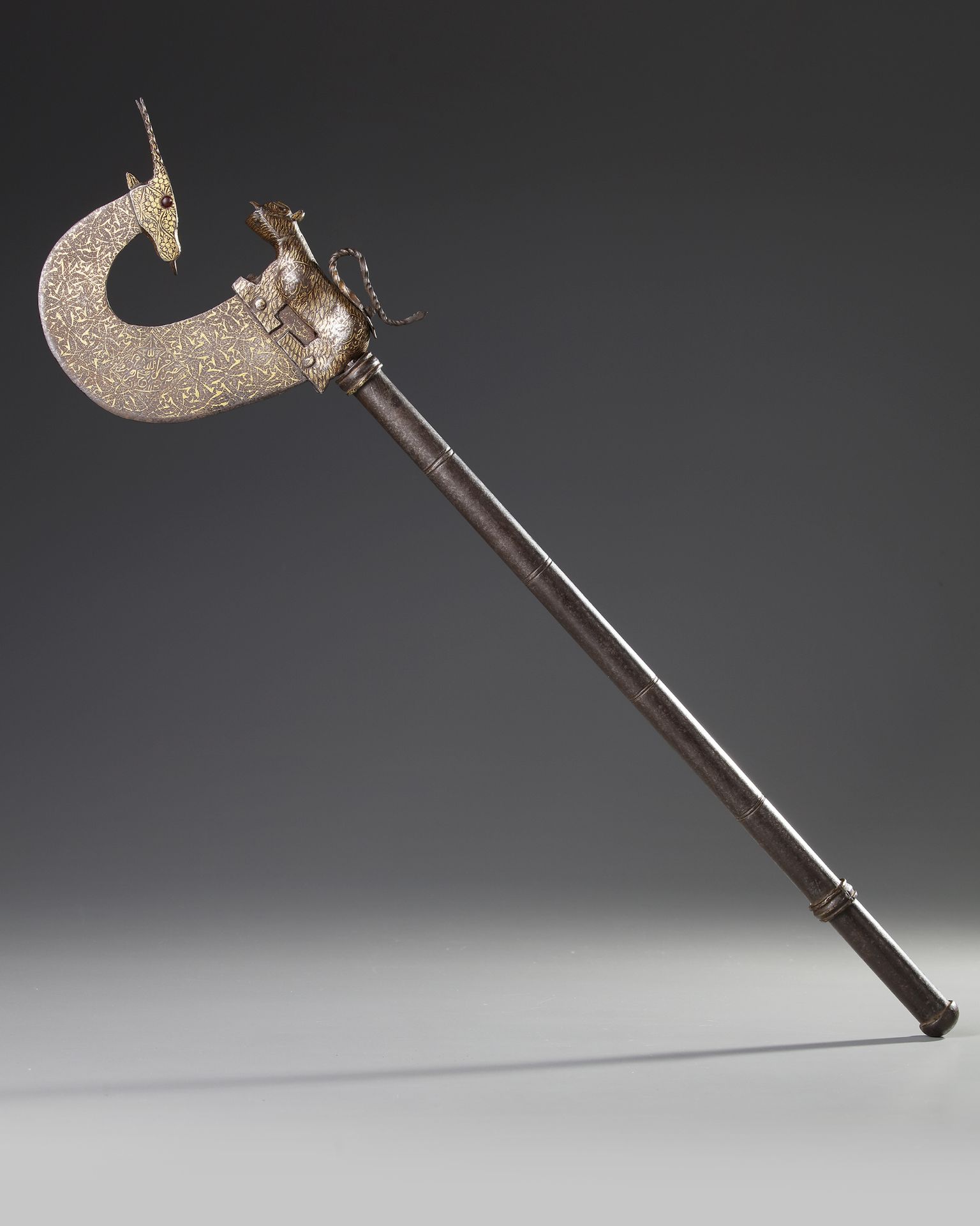 A CEREMONIAL GOLD-DAMASCENED STEEL AXE, INDIA, DATED 1120 AH/1708 AD