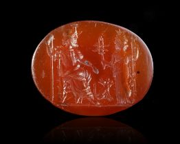 A CARNELIAN INTAGLIO SHOWING JUPITER SEATED WITH VICTORY, 2ND-3RD CENTURY AD