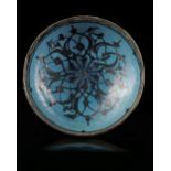 A KASHAN TURQUOISE AND BLACK DECORATED BOWL, PERSIA, 13TH CENTURY