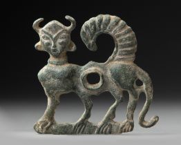 A HORSE BIT IN THE FORM OF A HUMAN-HEADED WINGED BULL, LURISTAN, CIRCA 900-800 BC