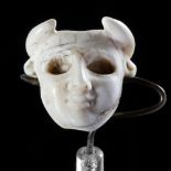 A SMALL AMULITIC HEAD OF A MAN HEADED BULL, NEAR EASTERN, 3RD MILLENNIUM BC