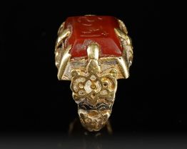 A SELJUK GOLD RING WITH ENGRAVED RED AGATE SEAL, ANATOLIA OR CENTRAL ASIA, 12TH-13TH CENTURY