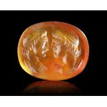 A ROMAN CARNELIAN INTAGLIO SHOWING THE BUSTS OF THE DIOSCURI, 1ST CENTURY AD