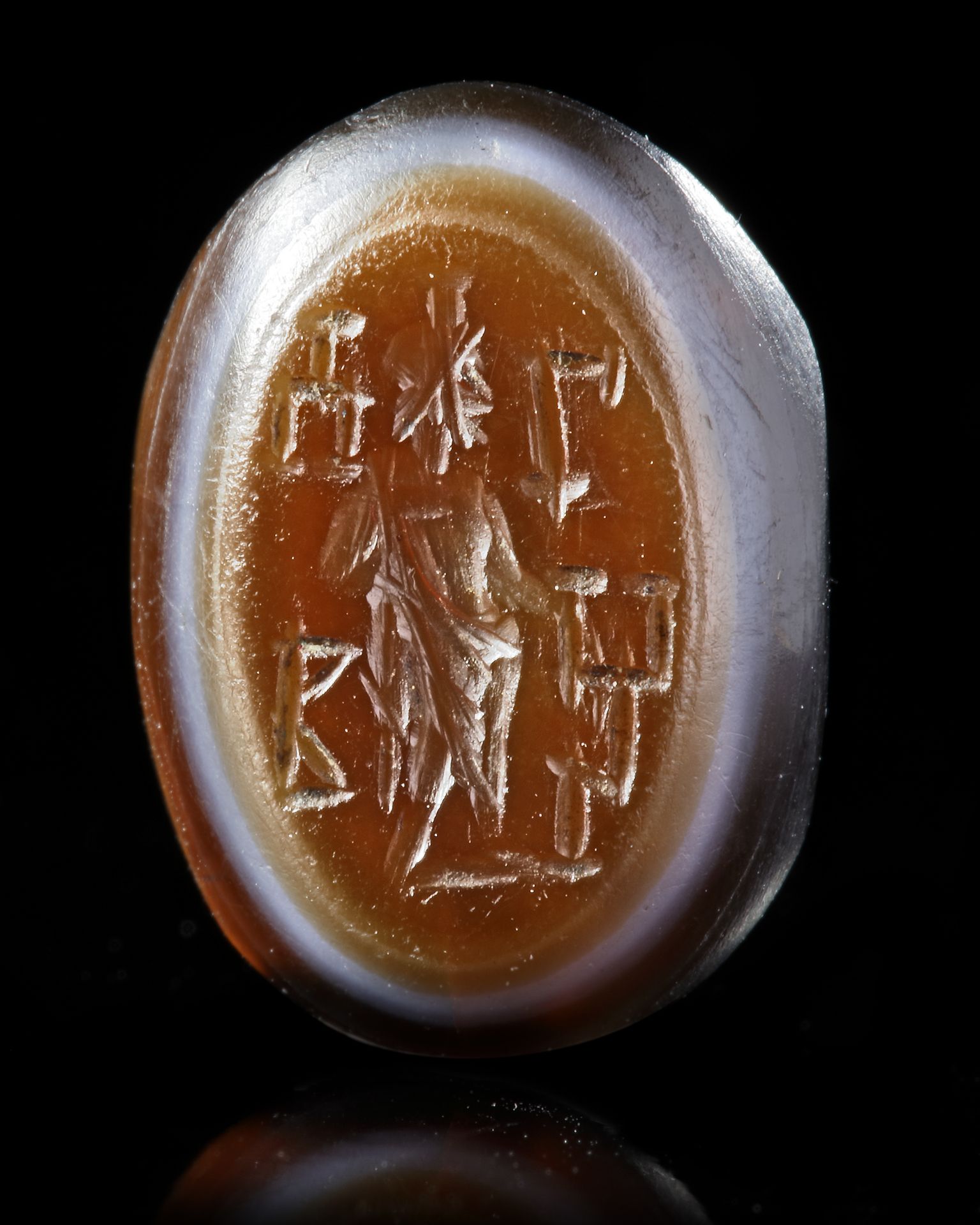 A BANDED AGATE ROMAN INTAGLIO OF SERAPIS, 1ST-2ND CENTURY AD
