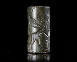 A GREEN CHALCEDONY CYLINDER SEAL, CIRCA 8TH-7TH CENTURY BC