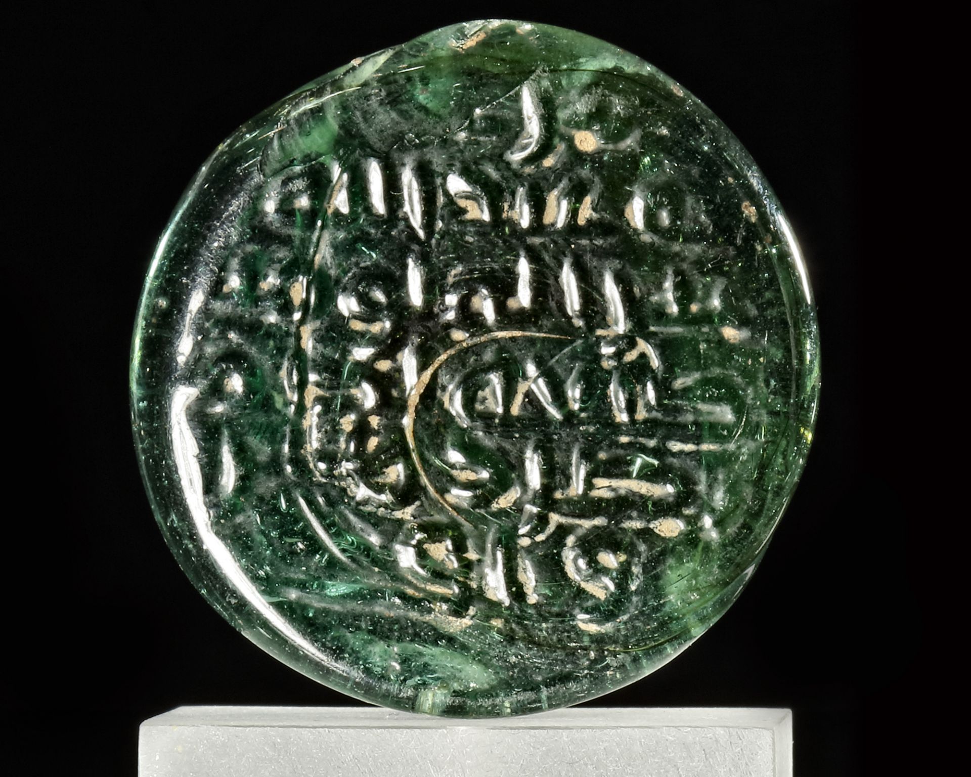 AN ISLAMIC GREEN GLASS LEAD SEAL ( BULLA), 9TH-10TH CENTURY