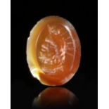 A ROMAN CARNELIAN INTAGLIO WITH A BUST OF SERAPIS, 1ST-2ND CENTURY AD