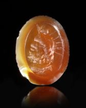 A ROMAN CARNELIAN INTAGLIO WITH A BUST OF SERAPIS, 1ST-2ND CENTURY AD