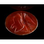 A ROMAN INTAGLIO IN CARNELIAN OF AN EAGLE FIGHTING A SNAKE, 2ND CENTURY AD