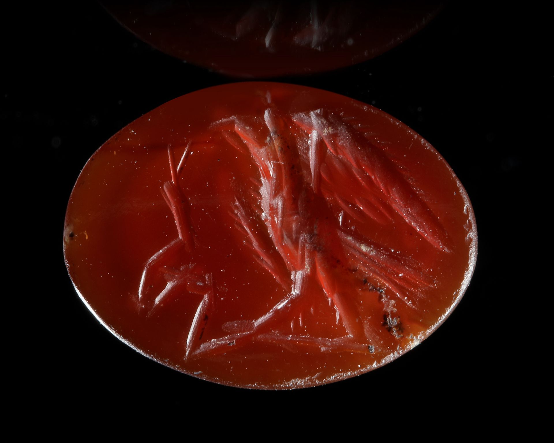A ROMAN INTAGLIO IN CARNELIAN OF AN EAGLE FIGHTING A SNAKE, 2ND CENTURY AD