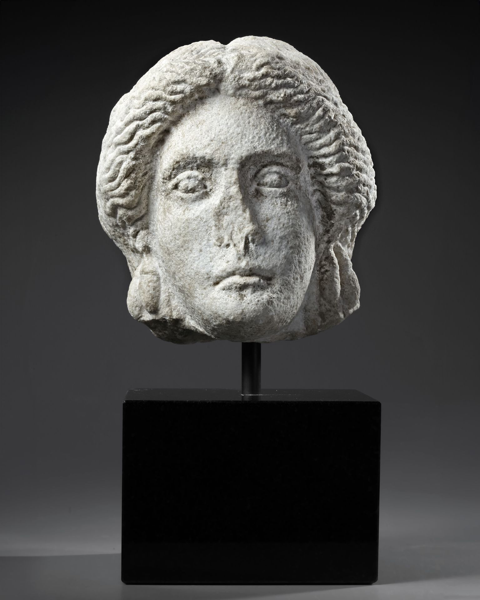 A MARBLE HEAD OF APOLLO, ROMAN 1ST CENTURY AD