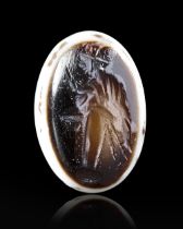 A ROMAN BANDED AGATE INTAGLIO OF A HERM OF PRIAPUS, 1ST CENTURY BC-AD