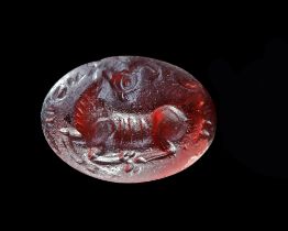 A SASSANIAN GARNET INTAGLIO WITH A RECLINING MOUNTAIN GOAT, 3RD-4TH CENTURY AD