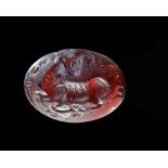 A SASSANIAN GARNET INTAGLIO WITH A RECLINING MOUNTAIN GOAT, 3RD-4TH CENTURY AD