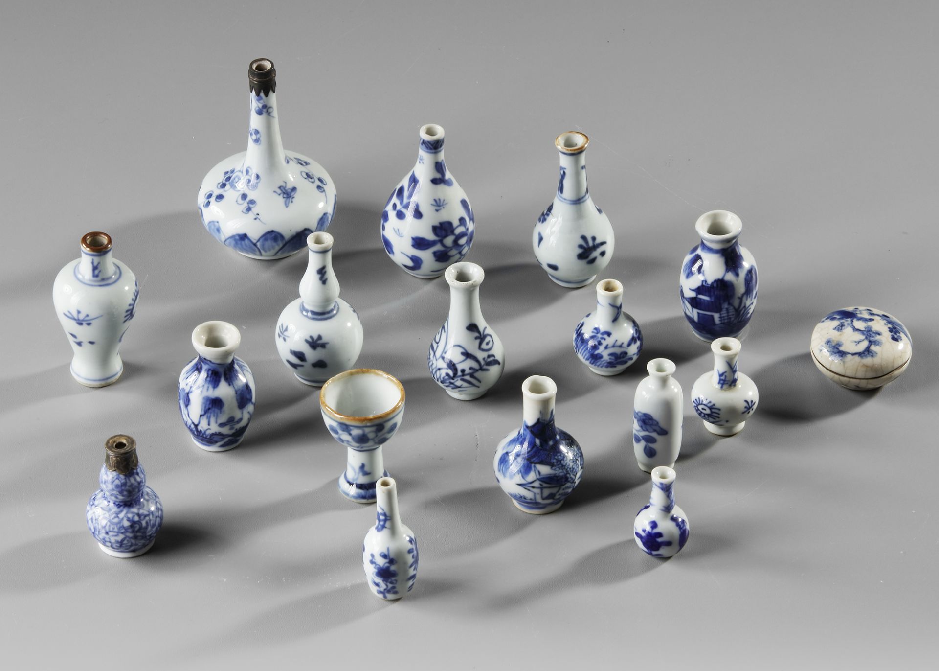 A COLLECTION OF 17 BLUE AND WHITE MINIATURE VASES, KANGXI-QIANLONG PERIOD AND LATER