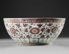 A LARGE CHINESE COPPER-RED 'FLORAL SCROLL' BOWL, QING DYNASTY (1644-1912)