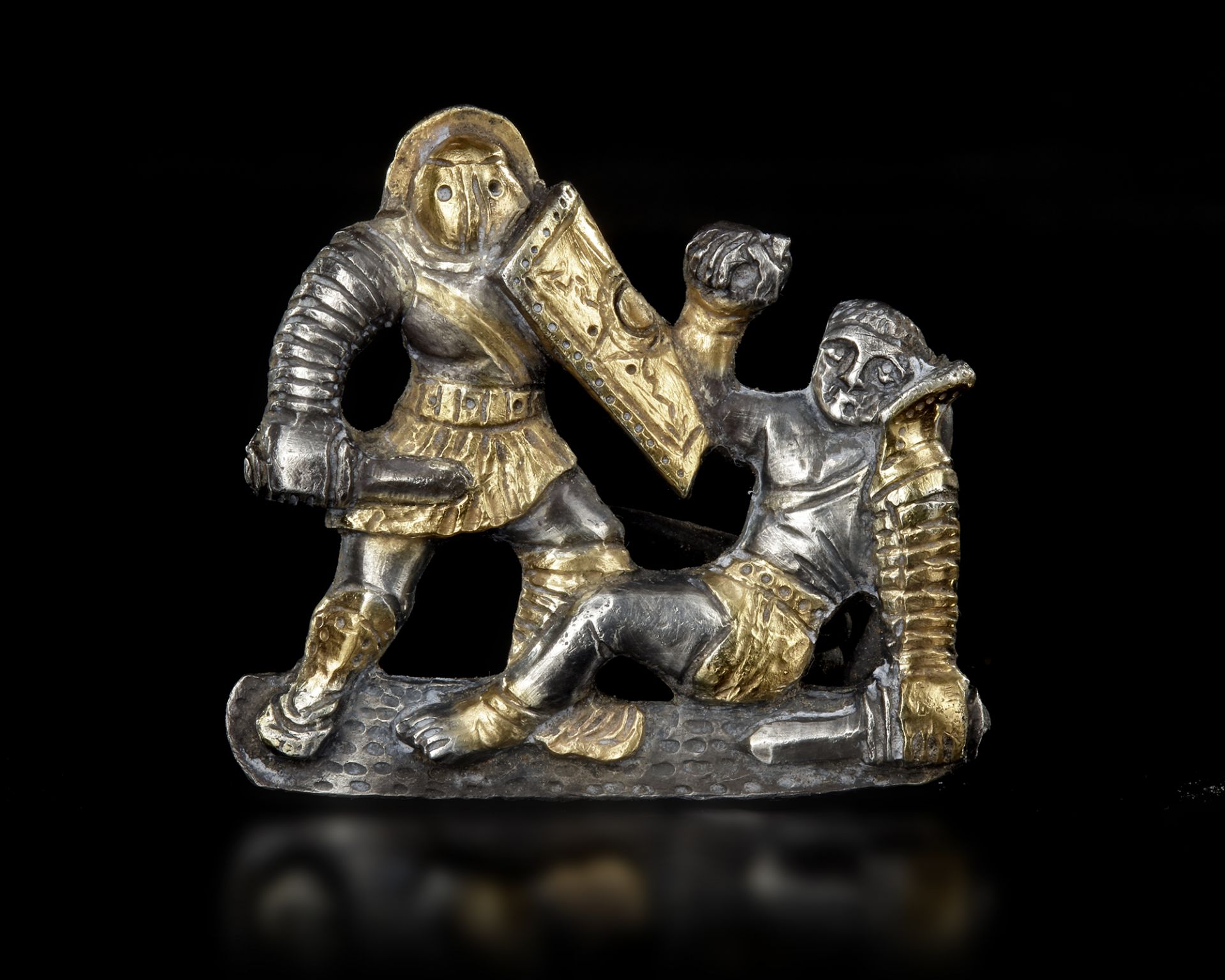 A SILVER GILT GLADIATORIAL BROOCH, 2ND-3RD CENTURY AD