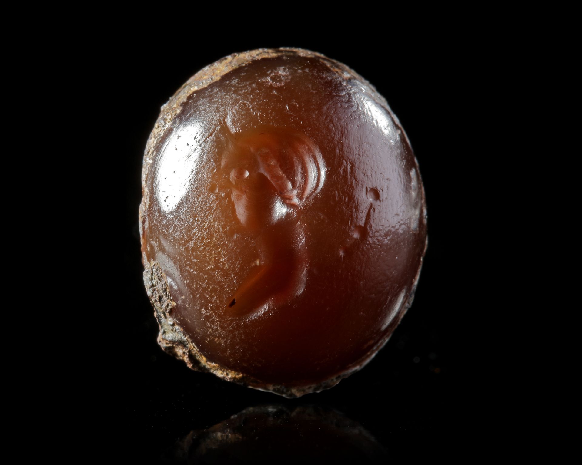 A BROWN AGATE INTAGLIO OF A FAUN, 2ND-1ST CENTURY BC