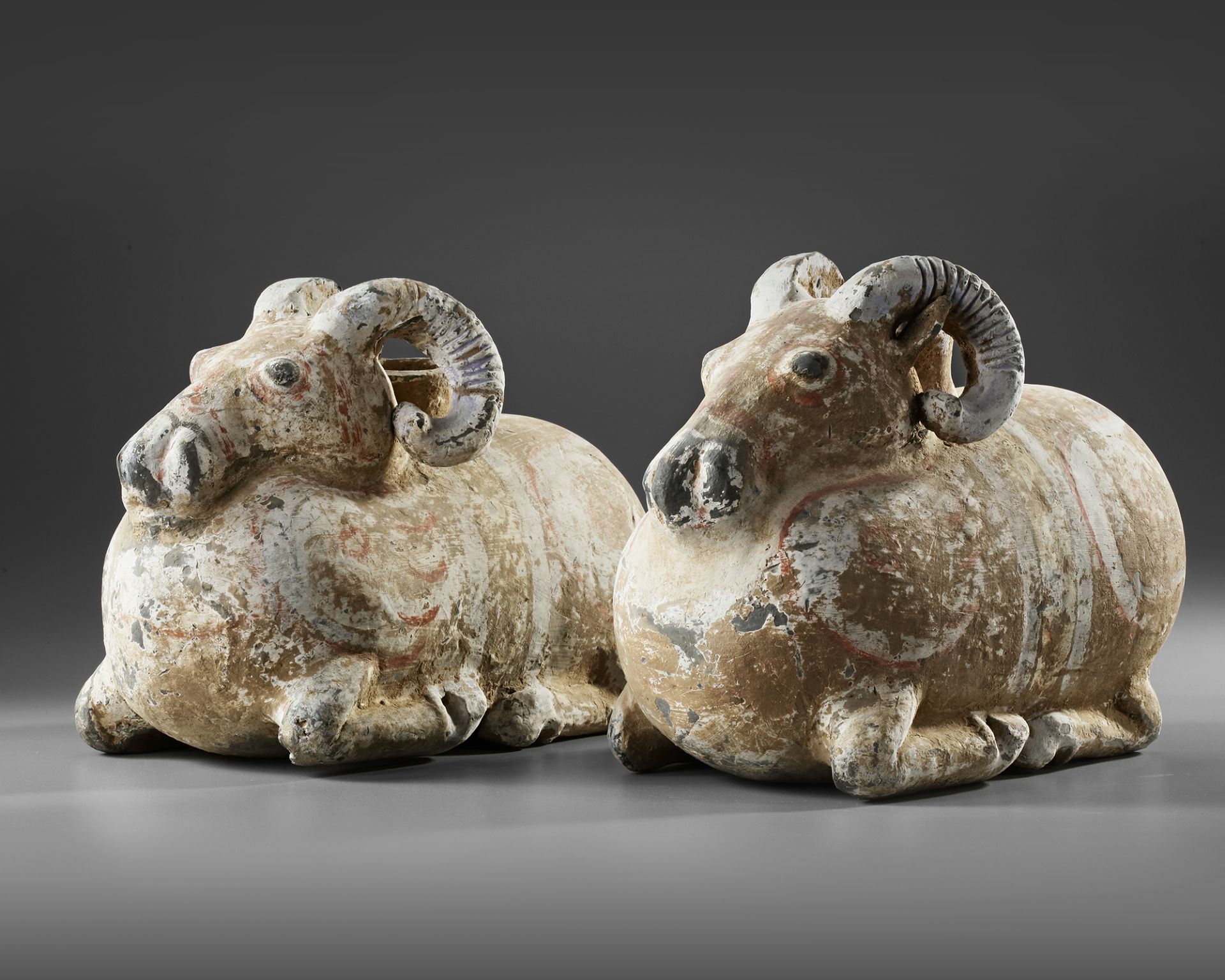 A PAIR OF TERRACOTTA VESSELS IN THE FORM OF A RAM, HAN DYNASTY (206 BC-220 AD)