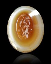 A SARDONYX INTAGLIO WITH A BUST OF JUPITER ABOVE AN EAGLE, 1ST CENTURY AD
