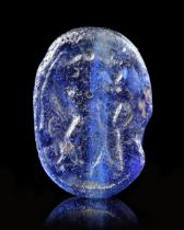 A BLUE GLASS SCARABOID SHOWING A MAN FIGHTING A LION, 6TH CENTURY BC