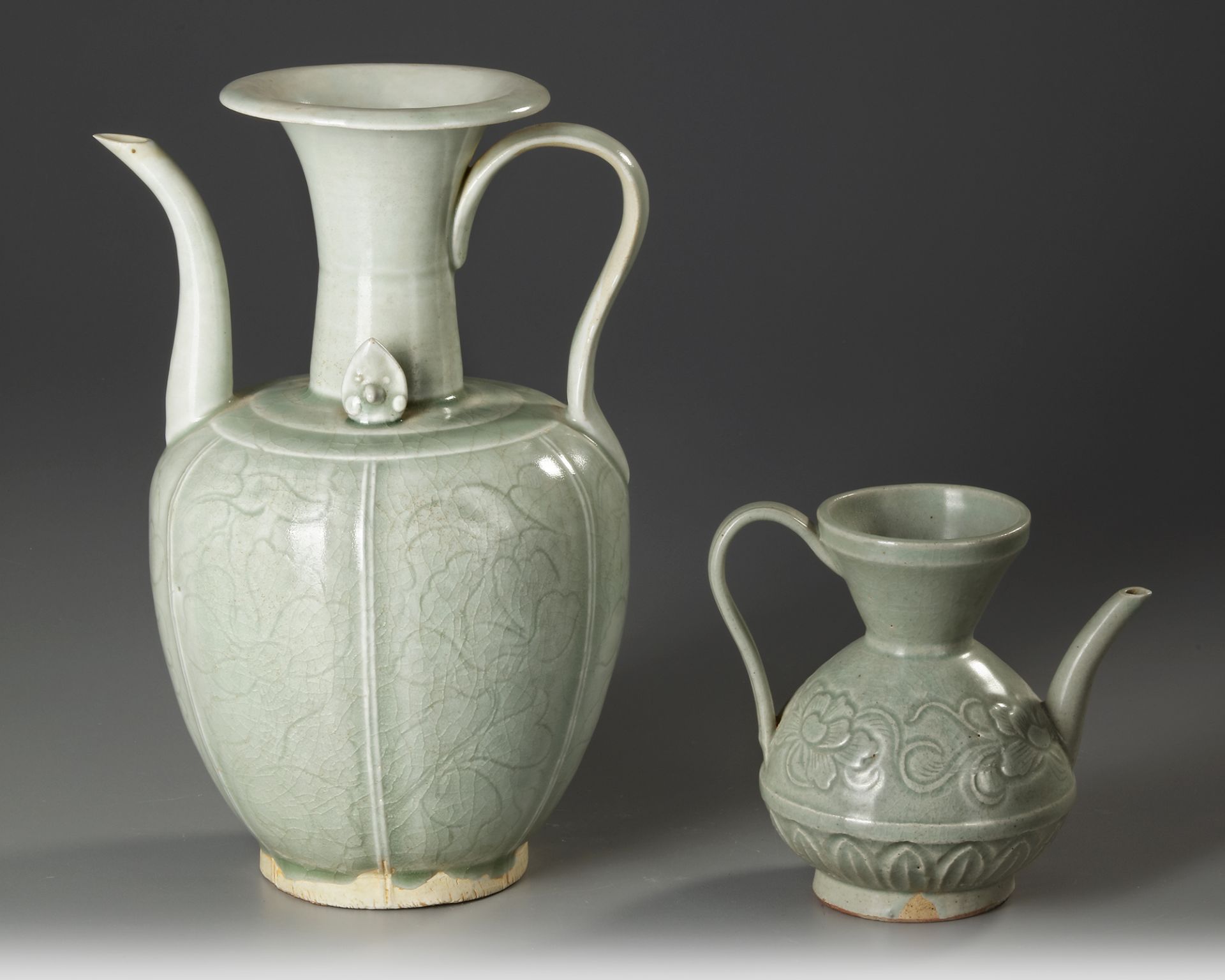 TWO CHINESE CELADON EWERS, SONG DYNASTY (960-1279 AD)/ MING DYNASTY (1368-1644)