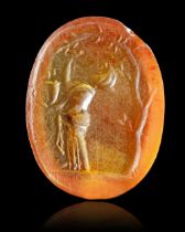 A ROMAN CARNELIAN INTAGLIO WOMAN WITH TREE, 1ST-2ND CENTURY AD