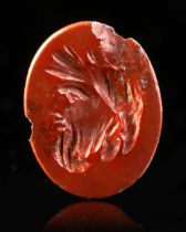 A RED JASPER INTAGLIO WITH A HEAD OF SILVANUS, 1ST CENTURY AD