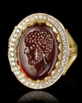 A ROMAN PORTRAIT INTAGLIO OF 'AELIUS' 2ND CENTURY AD, MOUNTED IN A 20 CENTURY GOLD RING, 18K WITH DI