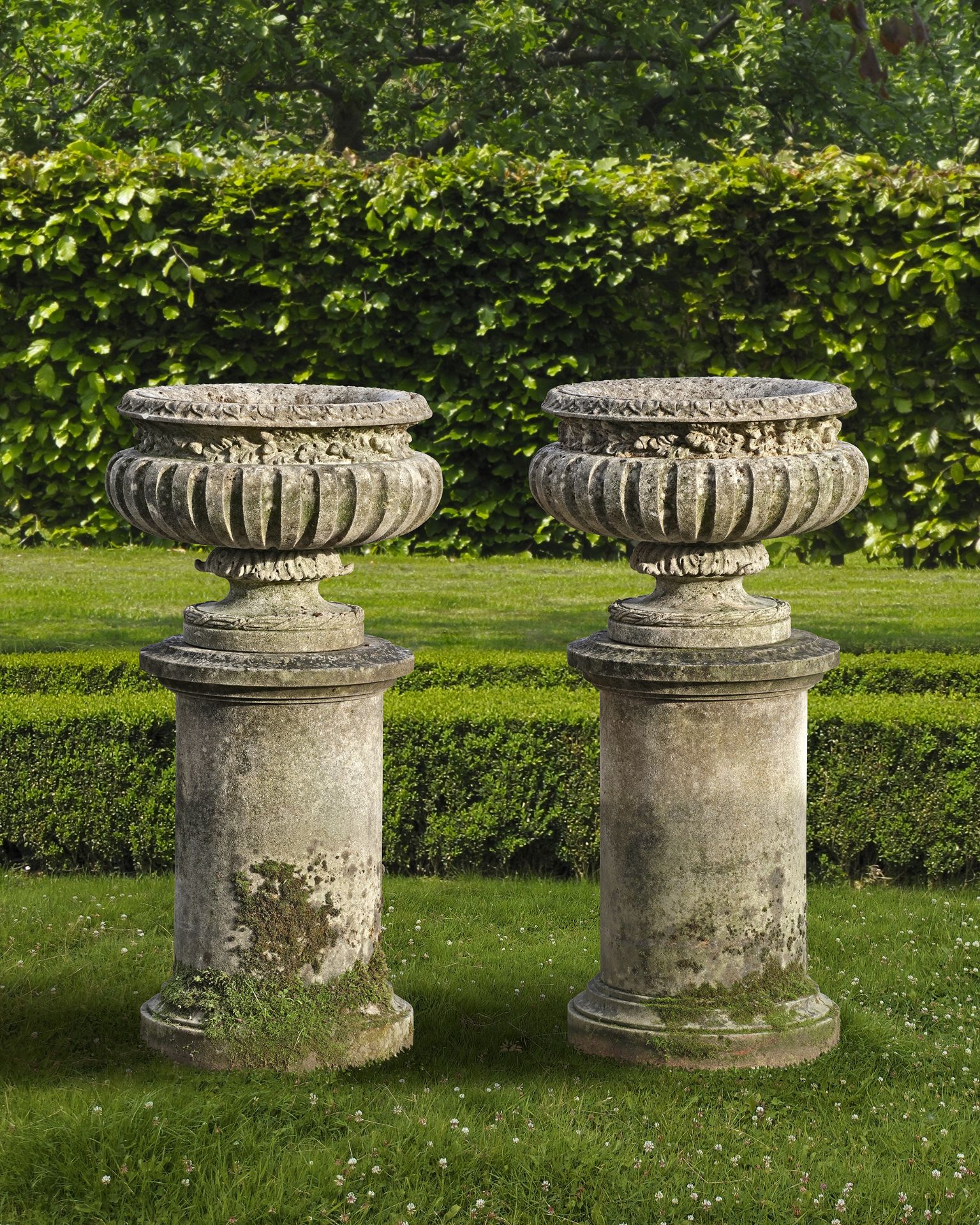 A PAIR OF CARVED LIMESTONE GARDEN URNS, 20TH CENTURY