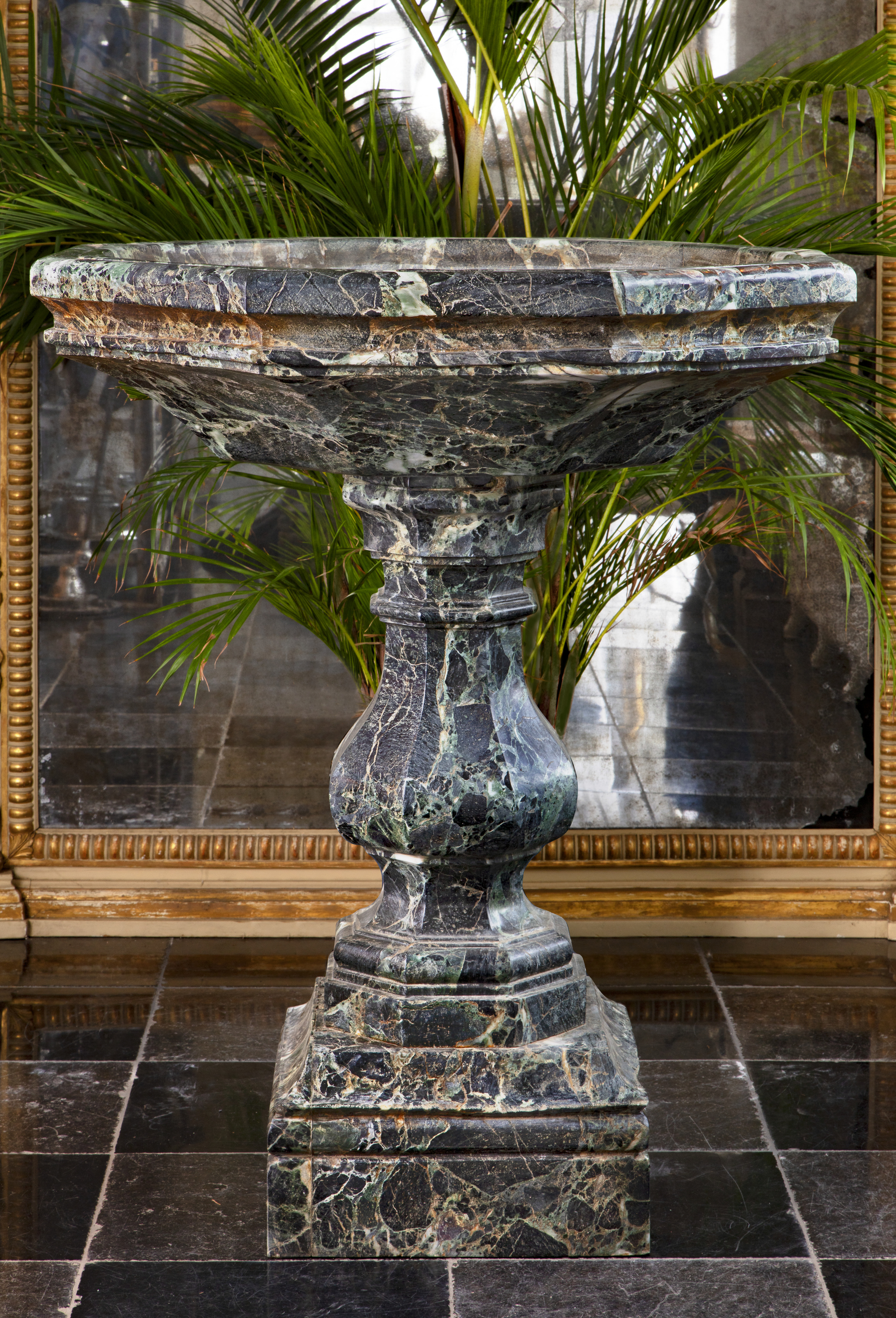 A CARVED VARIEGATED GREEN MARBLE BASIN OR CISTERN, LATE 19TH OR EARLY 20TH CENTURY