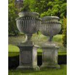 A PAIR OF LARGE AND IMPRESSIVE CARVED LIMESTONE GARDEN URNS ON PLINTHS IN IMPERIO TASTE, LATE 20TH C