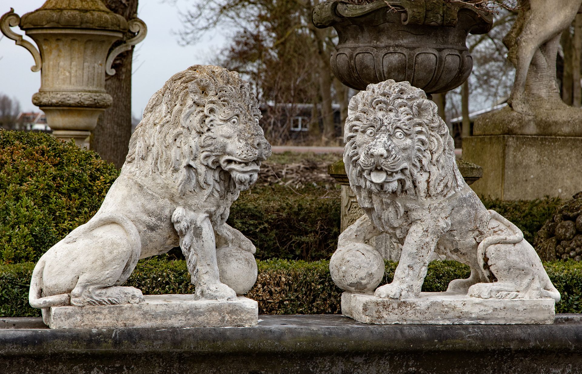 A PAIR OF COMPOSITION STONE MODELS OF LIONS IN THE 17TH CENTURY STYLE, LATE 19TH CENTURY