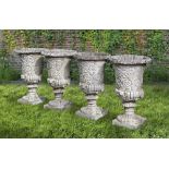 A SET OF FOUR WHITE COMPOSITION STONE GARDEN URNS IN THE ROMANTIC CLASSICAL MANNER, SECOND HALF 20TH
