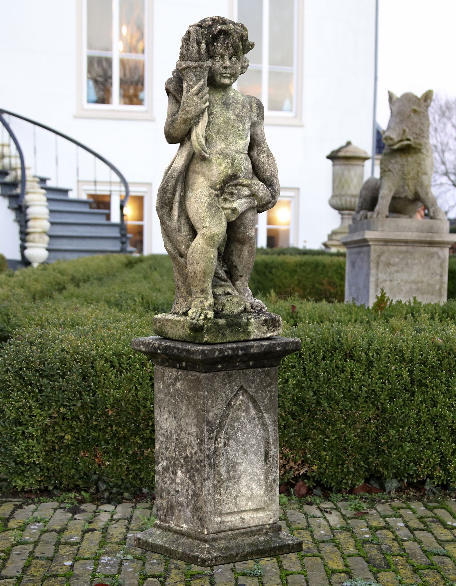 A SCULPTED LIMESTONE MODEL OF A TORCH-BEARER IN CLASSICAL TASTE, LATE 19TH CENTURY