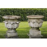 A PAIR OF FRENCH LIMESTONE GARDEN URNS ON PLINTHS, LATE 19TH CENTURY