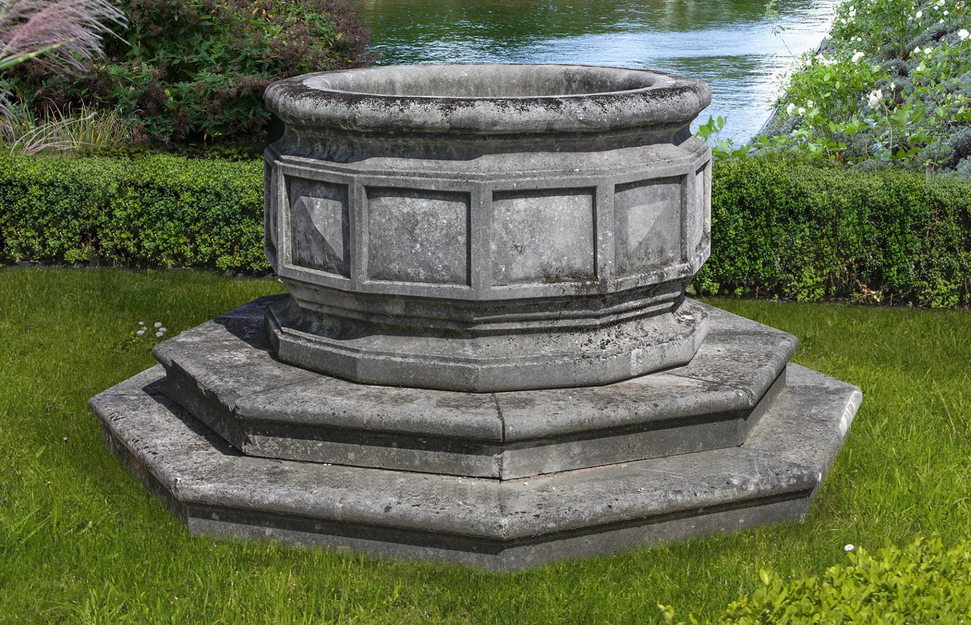 A LARGE CARVED STONE OCTAGONAL WELLHEAD/PLANTER, LATE 19TH CENTURY