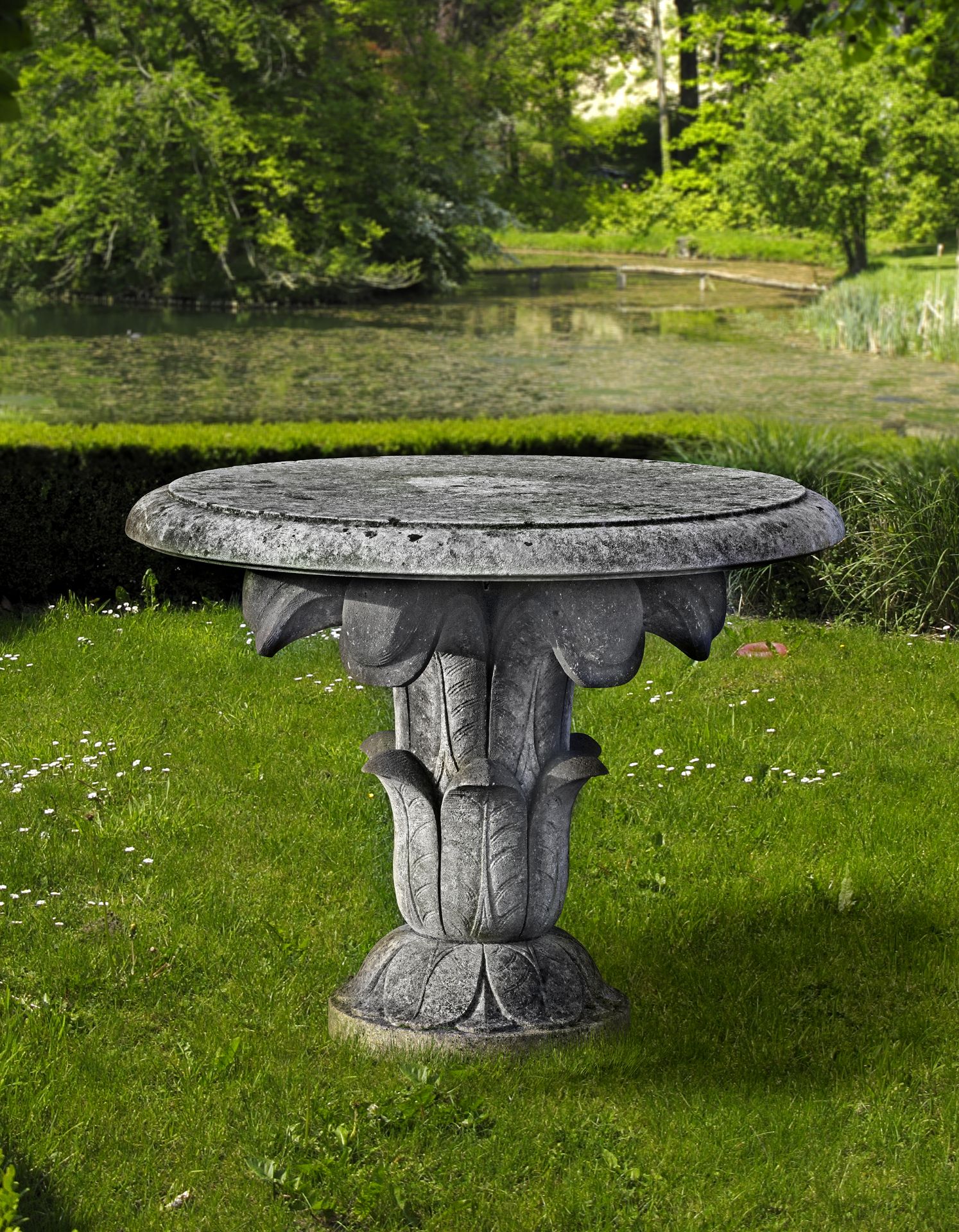 A CARVED LIMESTONE GARDEN TABLE IN THE EARLY 19TH CENTURY STYLE, SECOND HALF 20TH CENTURY