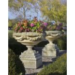 A PAIR OF CARVED LIMESTONE GARDEN URNS, LATE 20TH CENTURY