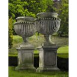 A PAIR OF LARGE AND IMPRESSIVE CARVED LIMESTONE GARDEN URNS ON PLINTHS IN IMPERIO TASTE, LATE 20TH C