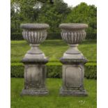 A PAIR OF CARVED LIMESTONE GARDEN URNS, 20TH CENTURY