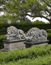 A PAIR OF SCULPTED LIMESTONE MODELS OF RECUMBENT LIONS, SECOND HALF 20TH CENTURY, AFTER ANTONIO CANO